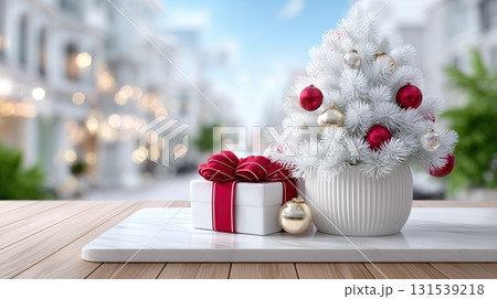 Elegant White Christmas Tree with Ornaments and Gift on Marble, Festive City Street Background 131539218