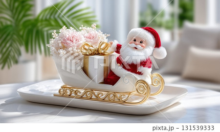 Santa Claus figurine in an elegant sleigh with gift and flowers on a festive marble table 131539333