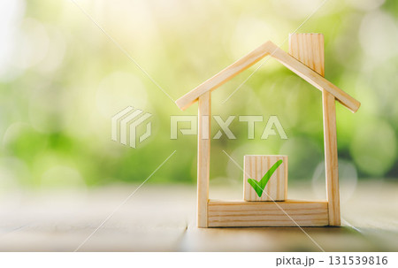 Mortgage and loan approved concept: Wooden model house place on the table. planning savings money of coins to buy a home concept for property. Mortgage and loan approved concept: Wooden model house place on the table. planning savings money of coins to buy a home concept for property. 131539816
