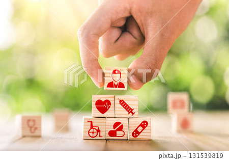 Hand arranged wooden blocks with icons of medical health. health insurance for your health concept. Healthcare medical business. 131539819