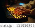 A person is typing on a keyboard with a ring on their finger 131539894