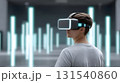 Immersive virtual reality experience with person wearing VR headset in futuristic environment filled with glowing vertical lights. scene evokes curiosity and exploration 131540860