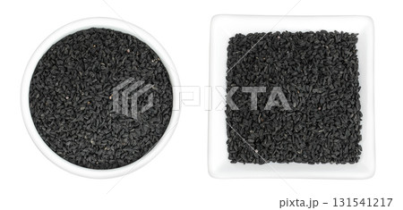 Nigella sativa or Black cumin in ceramic bowl isolated on white background. Top view. Flat lay. 131541217