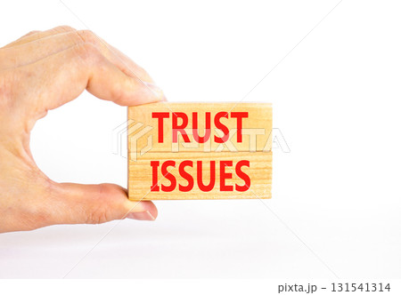 Trust issues symbol. Concept word Trust issues on beautiful wooden blocks. Beautiful white paper background. Businessman's hand. Business trust issues concept. Copy space. Trust issues symbol. Concept word Trust issues on beautiful wooden blocks. Beautiful white paper background. Businessman's hand. Business trust issues concept. Copy space. 131541314