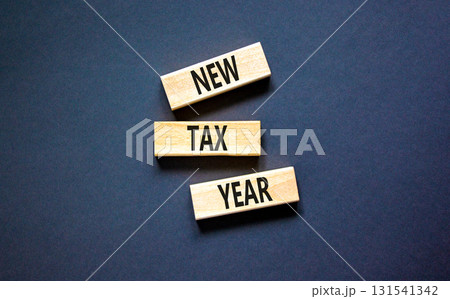 New tax year symbol. Concept words New tax year on beautiful wooden blocks. Beautiful black table black background. Business new tax year concept. Copy space. New tax year symbol. Concept words New tax year on beautiful wooden blocks. Beautiful black table black background. Business new tax year concept. Copy space. 131541342