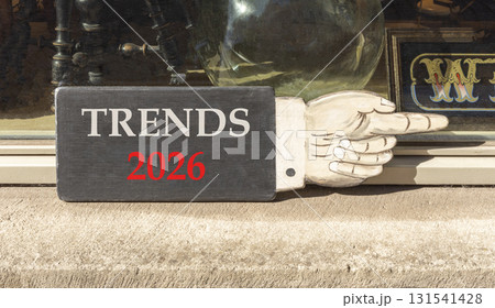 Trends 2026 new year symbol. Concept words Trends 2026 on beautiful black wooden hand sign. Beautiful shop display background. Business and Trends 2026 new year concept. Copy space. Trends 2026 new year symbol. Concept words Trends 2026 on beautiful black wooden hand sign. Beautiful shop display background. Business and Trends 2026 new year concept. Copy space. 131541428