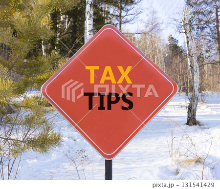 Tax tips symbol. Concept word Tax tips on beautiful red road sign. Beautiful snow winter forest background. Business tax tips concept. Copy space. Tax tips symbol. Concept word Tax tips on beautiful red road sign. Beautiful snow winter forest background. Business tax tips concept. Copy space. 131541429