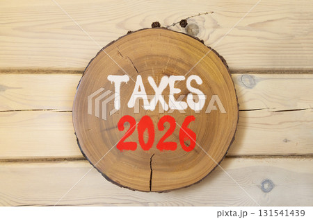 Taxes 2026 new year symbol. Concept words Taxes 2026 on beautiful wooden circle. Beautiful wooden wall background. Business and taxes 2026 new year concept. Copy space. Taxes 2026 new year symbol. Concept words Taxes 2026 on beautiful wooden circle. Beautiful wooden wall background. Business and taxes 2026 new year concept. Copy space. 131541439