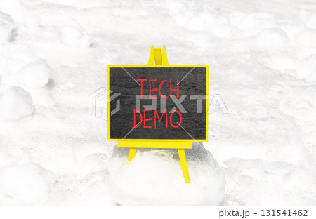 Tech demo symbol. Concept word Tech demo on beautiful black blackboard. Beautiful white snow background. White snow. Black blackboard. Business tech demo concept. Copy space. 131541462