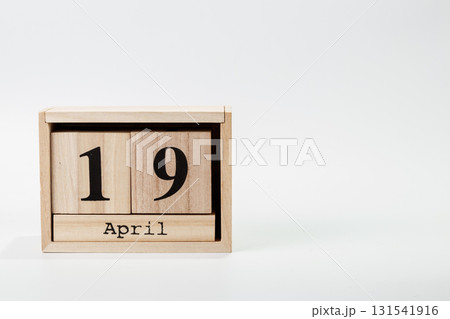 Wooden calendar April 19 on a white background Wooden calendar April 19 on a white background 131541916
