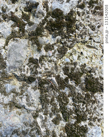 Weathered Stone Wall Texture Showing Cracks and Natural Vertical Patterns Weathered Stone Wall Texture Showing Cracks and Natural Vertical Patterns 131542008