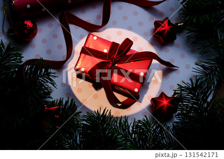 A Christmas background with a red polka dot gift. 131542171