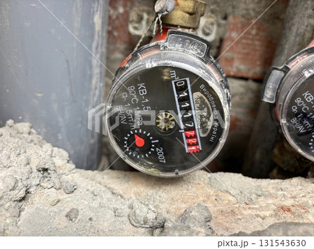 Water meter in a shaft of an apartment building. Utility counter for measuring water consumption Water meter in a shaft of an apartment building. Utility counter for measuring water consumption 131543630