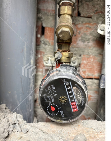Water meter in a shaft of an apartment building. Utility counter for measuring water consumption Water meter in a shaft of an apartment building. Utility counter for measuring water consumption 131543634