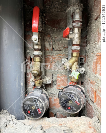 Water meter in a shaft of an apartment building. Utility counter for measuring water consumption Water meter in a shaft of an apartment building. Utility counter for measuring water consumption 131543635