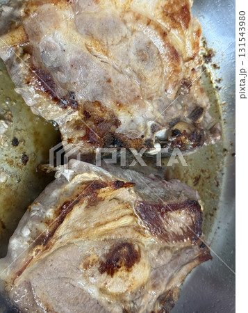 Closeup of a grilled pork chop. Pan-fried pork chops in frying pan. 131543980