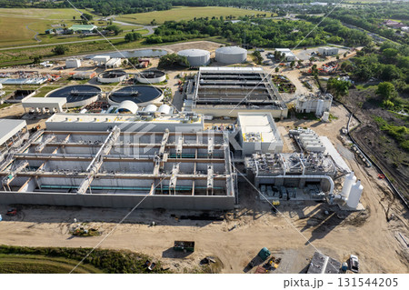 Large-scale industrial water treatment plant purifying and recycling water through filtration and chemical processes to meet health and safety standards Large-scale industrial water treatment plant purifying and recycling water through filtration and chemical processes to meet health and safety standards 131544205