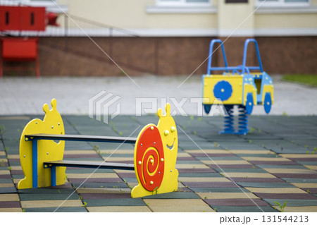 Kindergarten playground with bright toy car and funny bench. Children activities and recreation outdoors. Kindergarten playground with bright toy car and funny bench. Children activities and recreation outdoors. 131544213