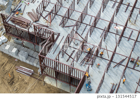 Development of commercial housing in USA. Construction works on monolithic frame. Large building site with scattered workers and equipment. Real estate market 131544517