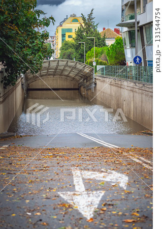 City underpass completely submerged after torrential rainfall, road markings. Concept of Weather and Climate, Flood, Storm Aftermath, Urban Environment, Transportation Disruption, Emergency Situations City underpass completely submerged after torrential rainfall, road markings. Concept of Weather and Climate, Flood, Storm Aftermath, Urban Environment, Transportation Disruption, Emergency Situations 131544754