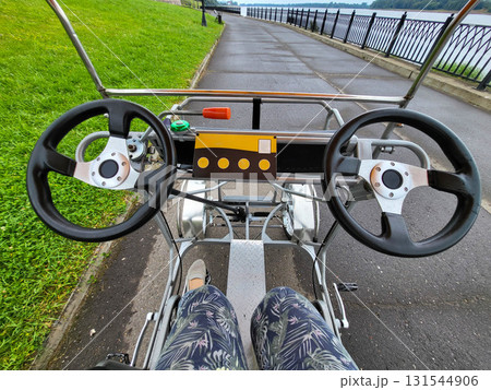 A ride on a two-seater bicycle with two steering wheels A ride on a two-seater bicycle with two steering wheels 131544906