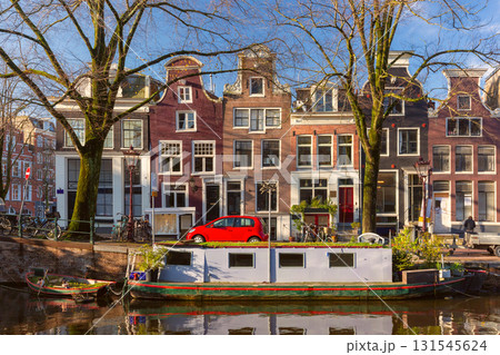 Canal house and boat in Amsterdam Netherlands Canal house and boat in Amsterdam Netherlands 131545624