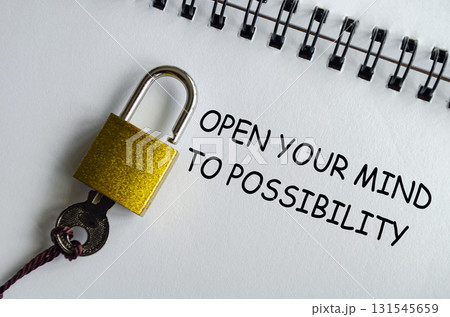 OPEN YOUR MIND TO POSSIBILITY, Inspirational notepad with padlock and key emphasizing opportunity. OPEN YOUR MIND TO POSSIBILITY, Inspirational notepad with padlock and key emphasizing opportunity. 131545659