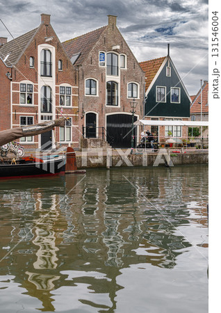 Charming view of Monnickendam, a traditional Dutch village with canals, historic houses, and serene atmosphere. Charming view of Monnickendam, a traditional Dutch village with canals, historic houses, and serene atmosphere. 131546004