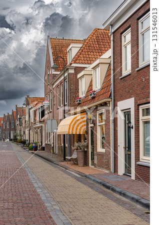 Charming view of Monnickendam, a traditional Dutch village with canals, historic houses, and serene atmosphere. Charming view of Monnickendam, a traditional Dutch village with canals, historic houses, and serene atmosphere. 131546013