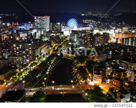 甲突川沿いから鹿児島市ナポリ通りの夜景の空撮 甲突川沿いから鹿児島市ナポリ通りの夜景の空撮 131547122