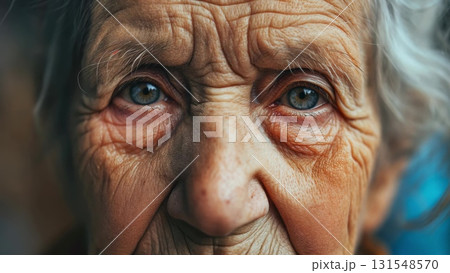 Elderly woman's weathered face revealing deep wrinkles, penetrating blue eyes reflecting lifetime of memories and quiet resilience 131548570