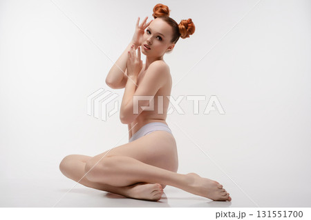 Elegant beauty captured in a serene studio topless pose with playful styling Elegant beauty captured in a serene studio topless pose with playful styling 131551700
