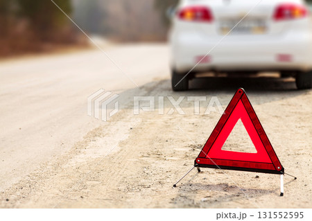 Red triangle sign and automobile on the road, shallow depth of view Red triangle sign and automobile on the road, shallow depth of view 131552595