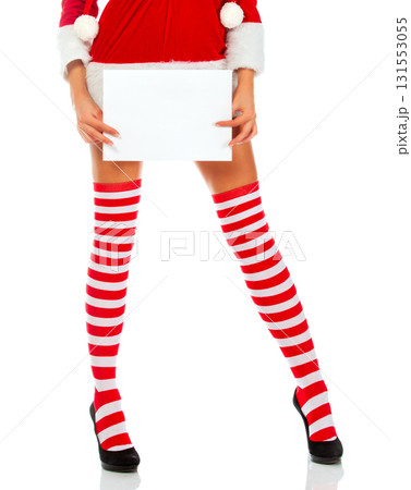 Young beautiful woman wearing christmas dress holding empty white banner over isolated background Young beautiful woman wearing christmas dress holding empty white banner over isolated background 131553055