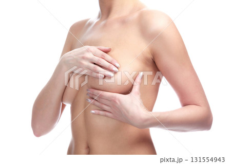 Woman controlling breast for cancer against a white background, isolated. Female healthcare concept 131554943