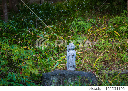 Jizo Buddist statue on rock at garden of Nisonin temple, Arashiyama 131555103