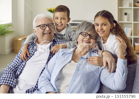 Portrait of happy, smiling grandparents together with grandson and granddaughter Portrait of happy, smiling grandparents together with grandson and granddaughter 131555790