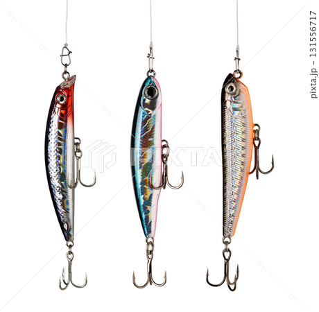Three fishing lures hanging on white background showing hooks 131556717