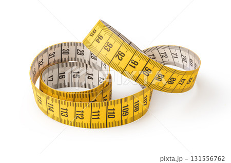 Yellow measuring tape curled and showing numbers for measuring length 131556762
