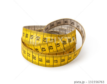 Yellow measuring tape coiled and showing numbers for measurement 131556763