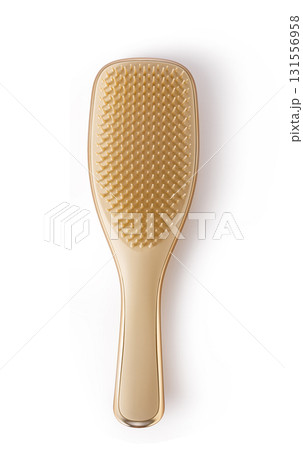 Golden hairbrush with ergonomic handle on transparent background 131556958
