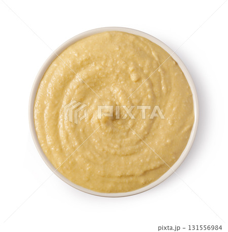 Creamy hummus rotating in a white bowl: top view 131556984