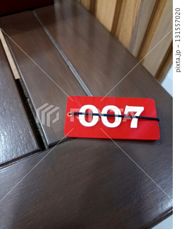 Lucky Number 007 Tag on Wooden Surface Lucky Number 007 Tag on Wooden Surface 131557020