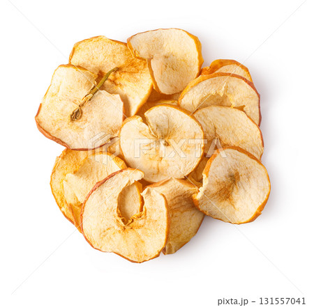 Dried apple chips forming round shape on white 131557041