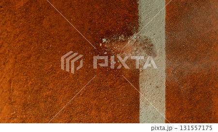 Freeze Motion Detail Shot of Tennis Ball Hitting a Clay Court Freeze Motion Detail Shot of Tennis Ball Hitting a Clay Court 131557175