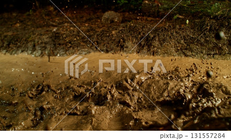 Freeze Motion Shot of Mud Splashing , Side View Freeze Motion Shot of Mud Splashing , Side View 131557284