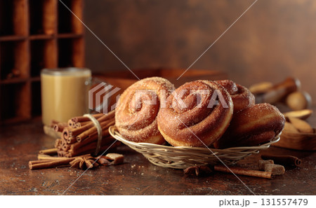 Swedish cinnamon rolls and coffee latte on a brown background. 131557479