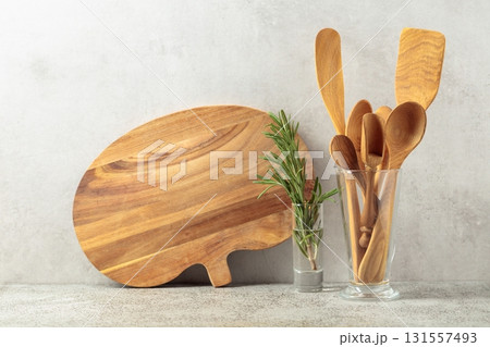 Wooden kitchen utensils and rosemary. Wooden kitchen utensils and rosemary. 131557493