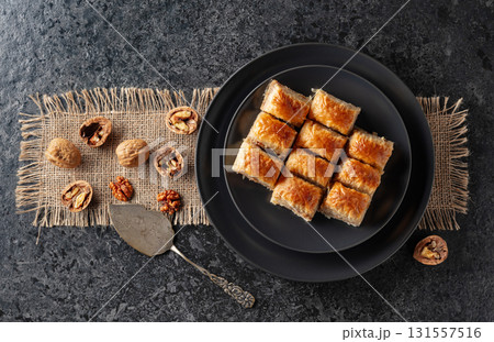 Baklava with walnuts on a blackstone table. 131557516
