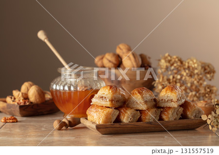 Baklava with walnuts and honey on a beige background. 131557519